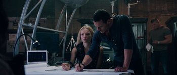 Movie still from “Fast & Furious 6” (2013), directed by Justin Lin – A man and a woman working together on a project; Medium shot, Over the shoulder angle