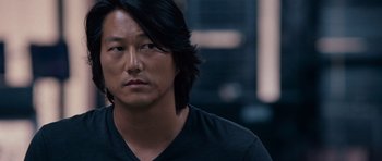 Movie still from “Fast & Furious 6” (2013), directed by Justin Lin – A person with long black hair; Close Up shot, Over the shoulder angle