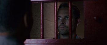 Movie still from “Fast & Furious 6” (2013), directed by Justin Lin – A person behind a fence; Close Up shot, Over the shoulder angle