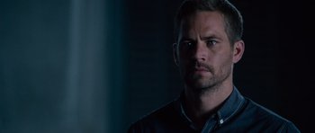 Movie still from “Fast & Furious 6” (2013), directed by Justin Lin – A person wearing a blue shirt; Close Up shot, Over the shoulder angle