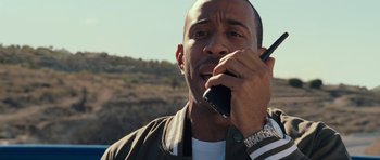 Movie still from “Fast & Furious 6” (2013), directed by Justin Lin – A person talking on a cell phone; Close Up shot, Over the shoulder angle