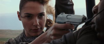 Movie still from “Fast & Furious 6” (2013), directed by Justin Lin – A person holding a gun; Close Up shot, Over the shoulder angle