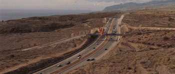 Movie still from “Fast & Furious 6” (2013), directed by Justin Lin – An aerial view of a highway with a fire coming from it; Extreme Wide shot, High angle