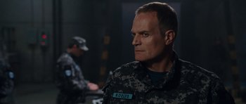 Movie still from “Fast & Furious 6” (2013), directed by Justin Lin – A person wearing a military uniform; Close Up shot, Over the shoulder angle