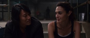 Movie still from “Fast & Furious 6” (2013), directed by Justin Lin – A man and a woman sitting next to each other; Close Up shot, Over the shoulder angle