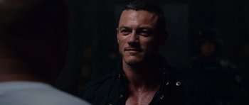 Movie still from “Fast & Furious 6” (2013), directed by Justin Lin – A person wearing a black shirt; Close Up shot, Over the shoulder angle