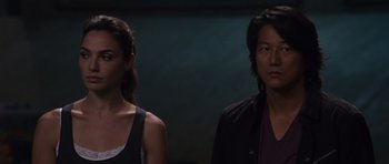 Movie still from “Fast & Furious 6” (2013), directed by Justin Lin – A man and a woman standing next to each other; Close Up shot, Over the shoulder angle