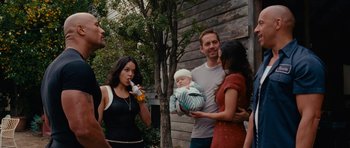 Movie still from “Fast & Furious 6” (2013), directed by Justin Lin – A group of people standing next to each other; Medium shot, Over the shoulder angle