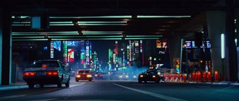 Movie still from “Fast & Furious 6” (2013), directed by Justin Lin – Cars driving down a street at night in a city; Extreme Wide shot, High angle
