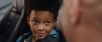 Movie still from “Fast X” (2023), directed by Justin Lin – A young boy's face with a person looking at him; Close Up shot, Over the shoulder angle