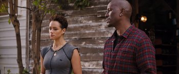 Movie still from “Fast X” (2023), directed by Justin Lin – A man and a woman standing next to each other; Medium shot, Over the shoulder angle