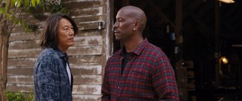 Movie still from “Fast X” (2023), directed by Justin Lin – A man and a woman standing next to each other; Medium shot, Over the shoulder angle