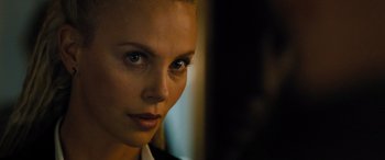 Movie still from “Fast X” (2023), directed by Justin Lin – A woman's face in a dark room; Close Up shot, Over the shoulder angle