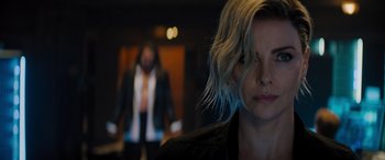 Movie still from “Fast X” (2023), directed by Justin Lin – A woman with blonde hair is looking at the camera; Close Up shot, Over the shoulder angle