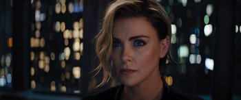 Movie still from “Fast X” (2023), directed by Justin Lin – A person with short blonde hair; Close Up shot, Over the shoulder angle