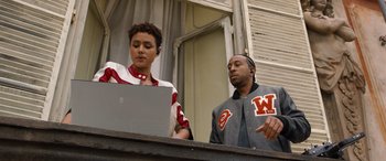 Movie still from “Fast X” (2023), directed by Justin Lin – A man and a woman standing in front of a laptop computer; Medium shot, Over the shoulder angle