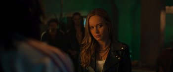 Movie still from “Fast X” (2023), directed by Justin Lin – A woman with long hair wearing a black leather jacket; Close Up shot, Over the shoulder angle