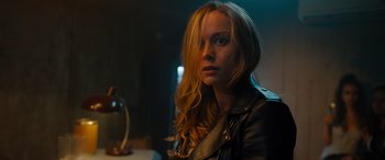 Movie still from “Fast X” (2023), directed by Justin Lin – A woman with long blonde hair wearing a leather jacket; Close Up shot, Over the shoulder angle