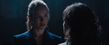 Movie still from “Fast X” (2023), directed by Justin Lin – A woman looking at her reflection in a mirror; Close Up shot, Over the shoulder angle