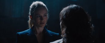 Movie still from “Fast X” (2023), directed by Justin Lin – A woman is talking to another woman in a dark room; Close Up shot, Over the shoulder angle