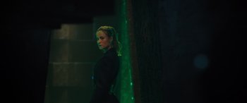 Movie still from “Fast X” (2023), directed by Justin Lin – A woman standing in front of a green wall; Medium shot, Over the shoulder angle