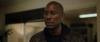 Movie still from “Fast X” (2023), directed by Justin Lin – A person wearing a leather jacket; Close Up shot, Low angle