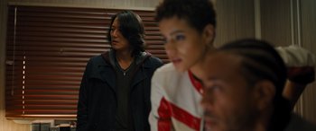 Movie still from “Fast X” (2023), directed by Justin Lin – A group of young men standing next to each other in a room; Medium shot, Over the shoulder angle