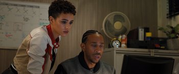 Movie still from “Fast X” (2023), directed by Justin Lin – A man and a woman looking at a computer screen; Close Up shot, Over the shoulder angle