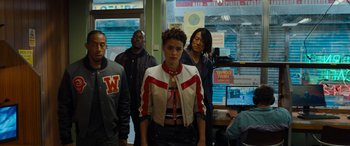 Movie still from “Fast X” (2023), directed by Justin Lin – A group of people standing in front of computer monitors; Medium shot, High angle