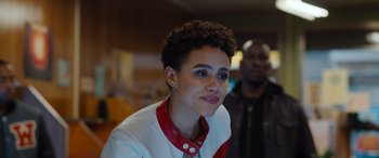 Movie still from “Fast X” (2023), directed by Justin Lin – A person wearing a red and white shirt; Close Up shot, Over the shoulder angle