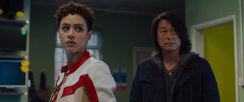 Movie still from “Fast X” (2023), directed by Justin Lin – Two people standing next to each other in front of a wall; Close Up shot, Over the shoulder angle