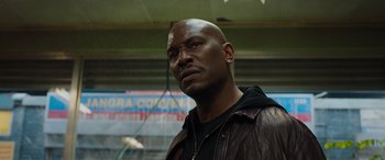 Movie still from “Fast X” (2023), directed by Justin Lin – A man in a leather jacket looking into the distance; Close Up shot, Low angle