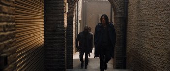 Movie still from “Fast X” (2023), directed by Justin Lin – A group of people walking down a brick walkway; Wide shot, Over the shoulder angle