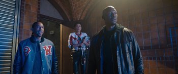 Movie still from “Fast X” (2023), directed by Justin Lin – A group of people standing next to each other in a room; Medium shot, Low angle