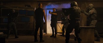 Movie still from “Fast X” (2023), directed by Justin Lin – A man taking a picture of a group of people; Wide shot, Low angle