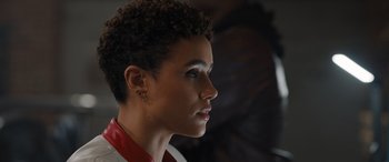 Movie still from “Fast X” (2023), directed by Justin Lin – A person wearing a red and white shirt; Close Up shot, Over the shoulder angle