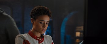 Movie still from “Fast X” (2023), directed by Justin Lin – A woman with a red and white shirt is looking down; Close Up shot, Low angle
