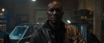 Movie still from “Fast X” (2023), directed by Justin Lin – A man in a leather jacket is looking at the camera; Close Up shot, Low angle