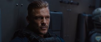 Movie still from “Fast X” (2023), directed by Justin Lin – A person wearing a vest; Close Up shot, Over the shoulder angle