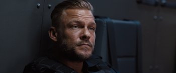 Movie still from “Fast X” (2023), directed by Justin Lin – A person wearing a black shirt; Close Up shot, Over the shoulder angle