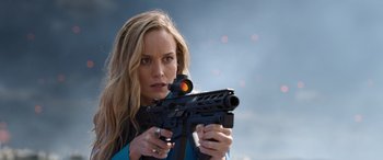 Movie still from “Fast X” (2023), directed by Justin Lin – A woman is holding a gun in her hands; Close Up shot, Over the shoulder angle