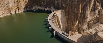 Movie still from “Fast X” (2023), directed by Justin Lin – An aerial view of a dam and a river; Extreme Wide shot, Overhead angle