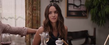 Movie still from “Father of the Bride” (2022), directed by Gary Alazraki – A beautiful young lady sitting at a table with a glass of wine in front of her; Close Up shot, Over the shoulder angle