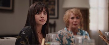 Movie still from “Father of the Bride” (2022), directed by Gary Alazraki – A woman sitting next to a woman holding a wine glass; Close Up shot, Over the shoulder angle