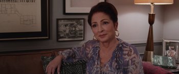 Movie still from “Father of the Bride” (2022), directed by Gary Alazraki – A person sitting in a chair; Close Up shot, Over the shoulder angle