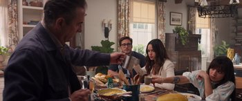 Movie still from “Father of the Bride” (2022), directed by Gary Alazraki – A group of people sitting around a table eating food; Medium shot, Over the shoulder angle
