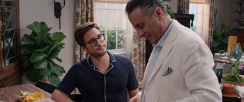 Movie still from “Father of the Bride” (2022), directed by Gary Alazraki – A man and a man in a room with a window; Medium shot, Over the shoulder angle