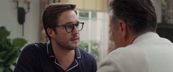 Movie still from “Father of the Bride” (2022), directed by Gary Alazraki – A man wearing glasses talking to another man in front of a window; Close Up shot, Over the shoulder angle