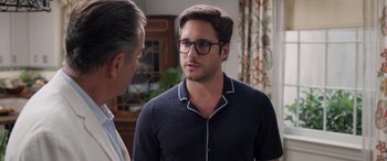 Movie still from “Father of the Bride” (2022), directed by Gary Alazraki – A young man wearing glasses talking to an older man; Medium shot, Over the shoulder angle
