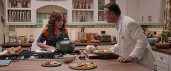 Movie still from “Father of the Bride” (2022), directed by Gary Alazraki – A man and a woman sitting at a table with plates of food; Medium shot, Over the shoulder angle